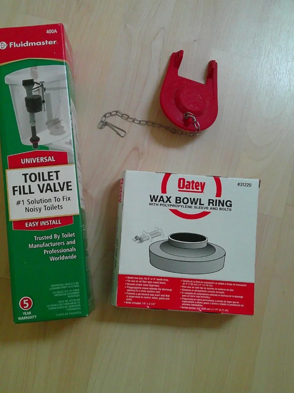 Fluidmaster Toilet Repair items flush valve, Oatey wax ring, & 2-Korky flappers.